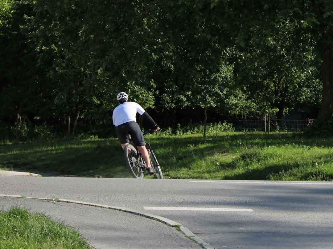 A cyclist enjoying a ride on a scenic road, emphasizing the joy of cycling