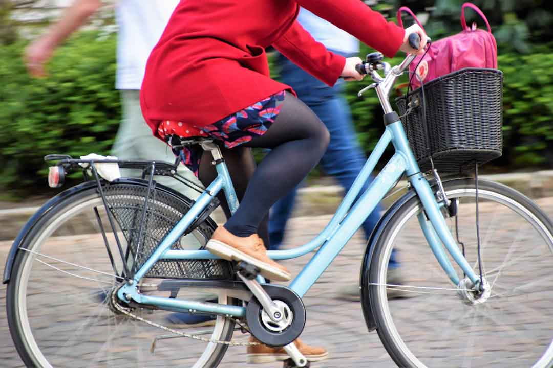 woman trying out different bicycles
